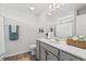 Fresh, modern bathroom features grey cabinets, a stylish vanity and a well-lit mirror at 259 Stillbrook Dr., Longs, SC 29568