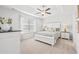 Bright bedroom showcasing a neutral palette, large window and tray ceiling with a ceiling fan at 259 Stillbrook Dr., Longs, SC 29568