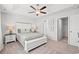 Comfortable bedroom features a tray ceiling, ceiling fan and adjoining closet and bathroom at 259 Stillbrook Dr., Longs, SC 29568
