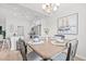Inviting dining area with a wooden table, chandelier, and view of the kitchen at 259 Stillbrook Dr., Longs, SC 29568