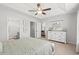 Main bedroom featuring a tray ceiling, ceiling fan, neutral decor and ensuite bathroom at 259 Stillbrook Dr., Longs, SC 29568