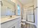 Bathroom with white vanity, framed mirror, and glass enclosed shower at 2593 Main St., Loris, SC 29569