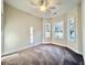 Bedroom featuring neutral walls, carpet flooring, a ceiling fan, and two windows for natural light at 2593 Main St., Loris, SC 29569