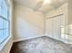 Bedroom featuring a ceiling fan, neutral carpet, and a closet with white bi-fold doors at 2593 Main St., Loris, SC 29569