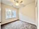 Bedroom featuring neutral walls, carpet flooring, a ceiling fan, and a large window for natural light at 2593 Main St., Loris, SC 29569