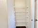 Walk-in closet with multiple levels of white wire shelving and door hardware at 2593 Main St., Loris, SC 29569