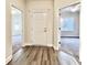 A newly constructed entryway, with stained laminate flooring, with views to two bedrooms at 2593 Main St., Loris, SC 29569