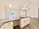 Modern kitchen island with granite countertops, sink, and white cabinetry at 2593 Main St., Loris, SC 29569