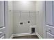 A utility or laundry room with shelving, electrical outlet, and pet door cutout at 2593 Main St., Loris, SC 29569
