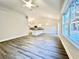 Bright open concept living area with plank flooring connecting to a modern kitchen at 2593 Main St., Loris, SC 29569