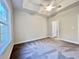 Spacious main bedroom features a trey ceiling, neutral carpet, and an ensuite bathroom at 2593 Main St., Loris, SC 29569
