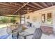 Back patio with a ceiling fan, a table with chairs, and an outdoor grill at 2604 South Bay St., Georgetown, SC 29440