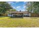 View of the backyard with a covered outdoor dining area surrounded by a wood fence at 2604 South Bay St., Georgetown, SC 29440