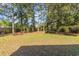 Lawn with some mature trees in the backyard of the property at 2604 South Bay St., Georgetown, SC 29440