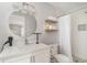 Modern bathroom featuring a new sink, round mirror, shower, and toilet at 2604 South Bay St., Georgetown, SC 29440