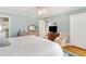 Bright bedroom with a ceiling fan, dresser with oval mirror, and wood floors at 2604 South Bay St., Georgetown, SC 29440