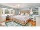 Serene bedroom with bay window, light blue walls, and beautiful wood bed frame at 2604 South Bay St., Georgetown, SC 29440