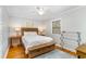 Bedroom featuring a wooden bed frame, hardwood floors, and two windows at 2604 South Bay St., Georgetown, SC 29440