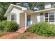Home's entrance with blue door, brick pathway, and manicured bushes at 2604 South Bay St., Georgetown, SC 29440