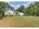 Charming single story home with blue door, manicured landscaping, and boat parked in front of the garage at 2604 South Bay St., Georgetown, SC 29440