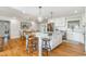 Bright, updated kitchen featuring a marble island with seating, pendant lighting, and stainless steel appliances at 2604 South Bay St., Georgetown, SC 29440