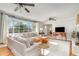 Bright and spacious living room with large windows, white sofa, and stylish decor at 2604 South Bay St., Georgetown, SC 29440