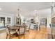 Open concept living room featuring a wooden table, stainless steel appliances, and view to the dining area at 2604 South Bay St., Georgetown, SC 29440