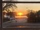 Picturesque water view through a window, featuring a vibrant sunset reflecting on the serene water at 2604 South Bay St., Georgetown, SC 29440