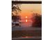 Stunning water view through a window, showcasing a vibrant sunrise reflected on the calm waters of the lake at 2604 South Bay St., Georgetown, SC 29440