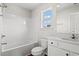 Well-lit bathroom featuring a tub-shower combo, sink, vanity, and a window providing natural light at 263 Stillbrook Dr., Longs, SC 29568