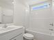 Clean bathroom featuring a sink, vanity, toilet, and tub-shower combo with white tile surround at 263 Stillbrook Dr., Longs, SC 29568