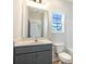Bathroom features a large mirror, modern vanity, and toilet next to the tub at 268 Stillbrook Dr., Longs, SC 29568