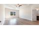 A spacious bedroom with a decorative tray ceiling and modern ceiling fan at 268 Stillbrook Dr., Longs, SC 29568