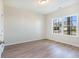 Bright bedroom showcasing a window with views of the neighborhood and light wood flooring at 268 Stillbrook Dr., Longs, SC 29568