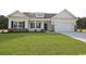 Charming one-story home with manicured lawn, brick accents and attached two-car garage at 268 Stillbrook Dr., Longs, SC 29568