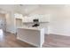 Modern kitchen with white cabinetry, stainless steel appliances, and center island with quartz countertops at 268 Stillbrook Dr., Longs, SC 29568
