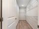 Bright walk-in closet featuring white walls, wooden floors and ample storage with wire shelving at 268 Stillbrook Dr., Longs, SC 29568