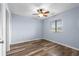Bedroom with vinyl plank flooring, ceiling fan, and natural light at 2700 S Ocean Blvd. # A-3, North Myrtle Beach, SC 29582