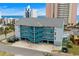 Coastal condo building with bright blue staircases and parking underneath, close to the beach at 2700 S Ocean Blvd. # A-3, North Myrtle Beach, SC 29582