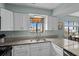Updated kitchen featuring white cabinets and granite countertops at 2700 S Ocean Blvd. # A-3, North Myrtle Beach, SC 29582