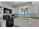 Updated kitchen showcasing granite countertops and black appliances at 2700 S Ocean Blvd. # A-3, North Myrtle Beach, SC 29582