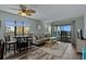 Living room with ocean view through sliding door to screened in patio, coastal decor, wood flooring at 2700 S Ocean Blvd. # A-3, North Myrtle Beach, SC 29582
