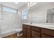 Bathroom featuring double sink vanity, a shower, and a window to let in natural light at 271 Stillbrook Dr., Longs, SC 29568