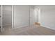 Bright, carpeted bedroom with a view to the walk-in closet and adjoining room at 271 Stillbrook Dr., Longs, SC 29568