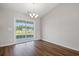 Bright dining room featuring wood flooring and a sliding glass door to the backyard at 271 Stillbrook Dr., Longs, SC 29568