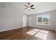 Bright living room with wood floors, ceiling fan, and large windows allowing natural light at 271 Stillbrook Dr., Longs, SC 29568
