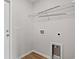 Well-lit laundry room featuring a utility sink, white shelving, and washer/dryer hookups at 275 Stillbrook Dr., Longs, SC 29568