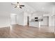 Open-concept living space with hardwood floors, and modern kitchen with island at 275 Stillbrook Dr., Longs, SC 29568