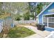 Charming backyard featuring a well-maintained lawn, a white picket fence, and a patio with outdoor seating at 284 Nature Trail, Little River, SC 29566
