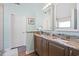 Bathroom with a double vanity, granite countertops, stylish mirrors, and tile flooring at 284 Nature Trail, Little River, SC 29566